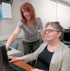 Joyce Golden, instructor from Erie 2-Chautauqua-Cattaraugus BOCES, assists Cathy Hamlet during a computer class at Prendergast Library, where the schedule of April classes is available.