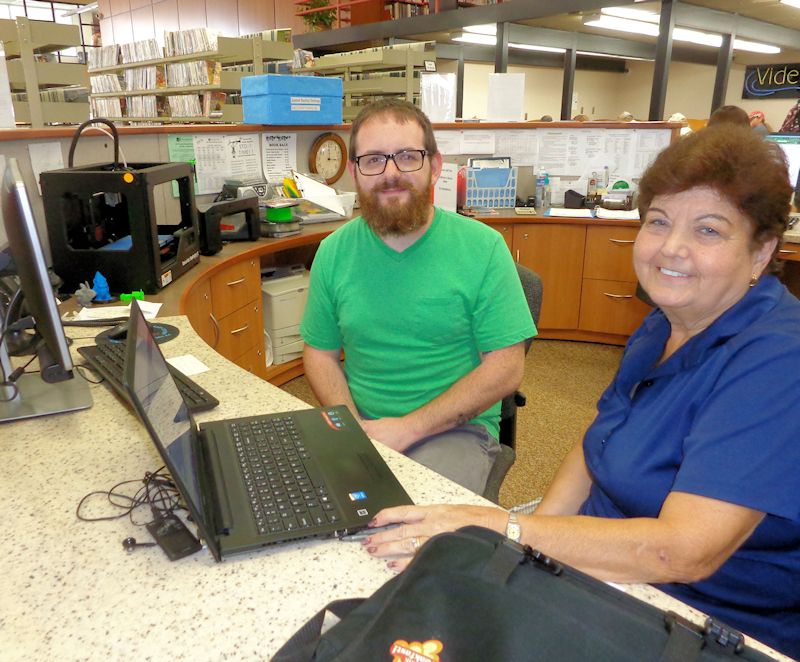 Carm Micciche of Jamestown learns more about the process of downloading eBooks and audiobooks to her computer from Library Associate Jason Cline at Prendergast Library, where information is available about computer classes and individual instruction being offered this month.