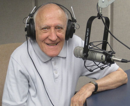 Photo of Jim Roselle sitting in front of a microphone