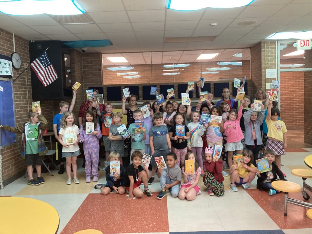 Children pose with books